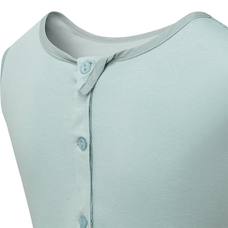 Close up view of the back of ScratchSleeves children's Seafoam dungarees, shows the reinforced opening at the back, from the neck down with green buttons holding it closed. Additional button to the right with loop closure and extra tab which folds over to the neckline with button fastening to keep it secure. Seafoam green sleeveless body in 100% cotton jersey with grey woven cotton trim on the neck.