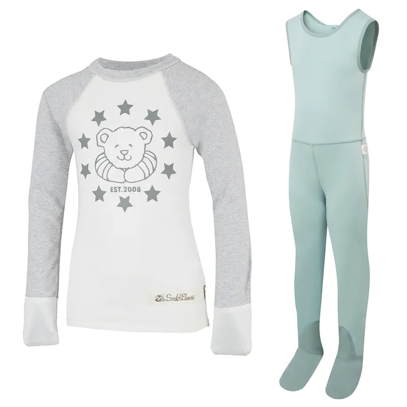 Front view of baseball style ScratchSleeves pyjama top with external shoulder, neck and hem seams. White body with grey printed logo featuring a bear, stars and est.2008. Grey marl neck and sleeves, with white sewn in mitts. 100% cotton body and 100% natural silk mitts. External label and branding on the left side towards the base of the top. Front view of ScratchSleeves seafoam dungarees with no inside leg seam and sewn in feet. Closed feet with a layer of grey, 100% woven cotton over the front of the foot and under the toe. Seafoam green, sleeveless body in 100% cotton jersey, edged in grey woven cotton trim on the arm and neck.